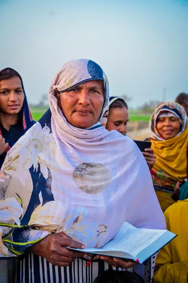 A woman reads the Scriptures she has just been given