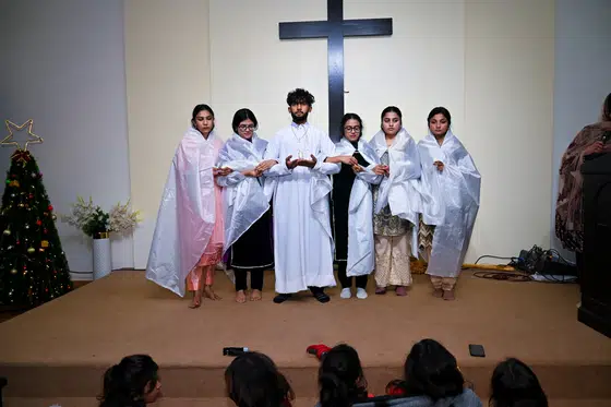 The choir in white robes at the Christmas service