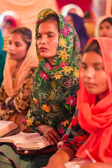Two women follow the reading in an open Bible
